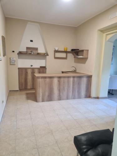 a kitchen with a wooden counter in a room at Agriturismo Cara Terra Lucana in Chiaromonte