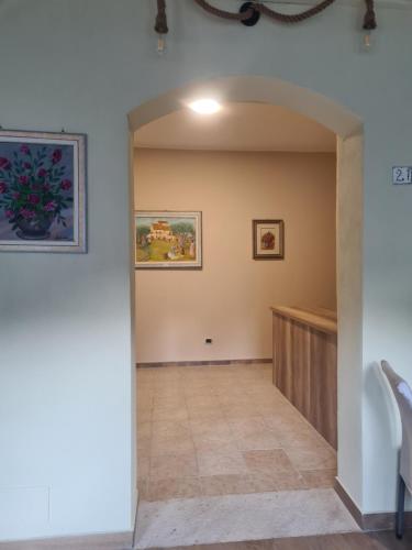 a hallway in a house with paintings on the wall at Agriturismo Cara Terra Lucana in Chiaromonte
