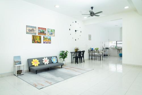 a living room with a couch and a table at 5 stars Rawang homestay in Rawang