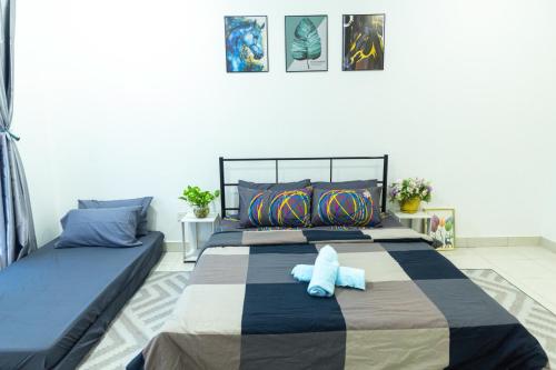 a bedroom with a bed with a blue stuffed animal on it at 5 stars Rawang homestay in Rawang