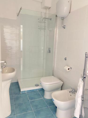 a bathroom with a toilet and a sink and a shower at Villa Mariel Suites & Apartment in Massa Lubrense