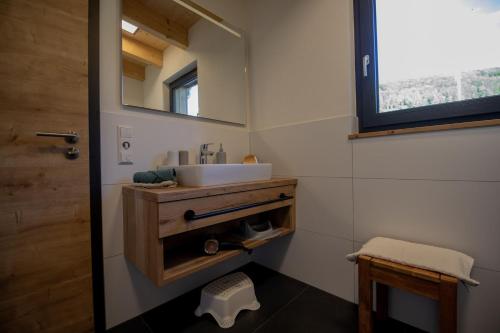 a bathroom with a sink and a mirror at An Webers Stoag in Geisingen