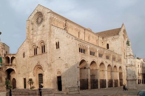 a large stone building with a clock on it at Republic B&B in Bitonto