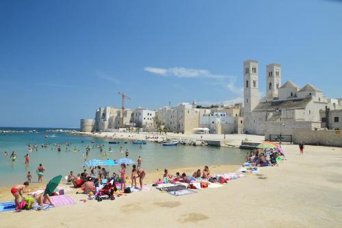 a group of people on a beach in the water at Republic B&B in Bitonto