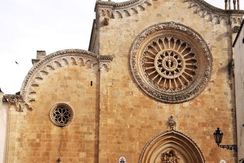 a tall building with a clock tower and a window at Republic B&B in Bitonto