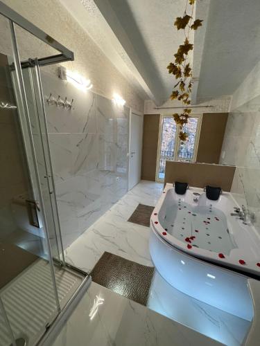 a bathroom with a tub and a shower and a sink at L'oasi del raganello in Civita