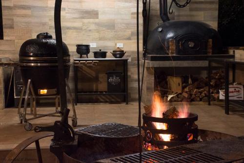 a kitchen with a stove with a fire in it at Momora distrito selva in Santa Ana