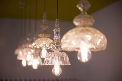 a group of chandeliers hanging from a ceiling at Fresh Hotel, a member of Design Hotels in Athens