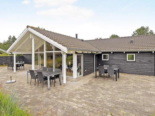 Hedensted - Nordjyllandにある10 person holiday home in lb kの家の前のパティオ(テーブル、椅子付)