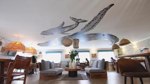 a living room with dolphins on the ceiling at WOT Ericeira in Ericeira