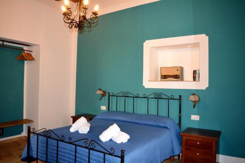 a blue bedroom with a bed and a mirror at Verderame - Apartment in Licusati