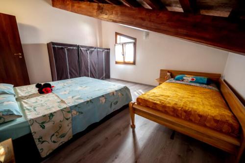 a bedroom with two beds and a teddy bear sitting on the bed at Casa de Vacanță S&B in Braşov