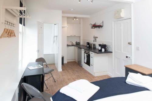a small room with a bed and a kitchen at The Royal Burnham Yacht Club in Burnham on Crouch