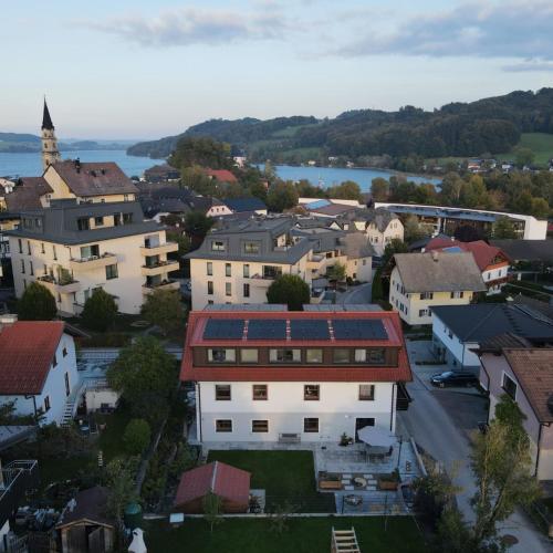 an aerial view of a town with buildings and a river at Gästehaus & Vinothek Strasser in Mattsee