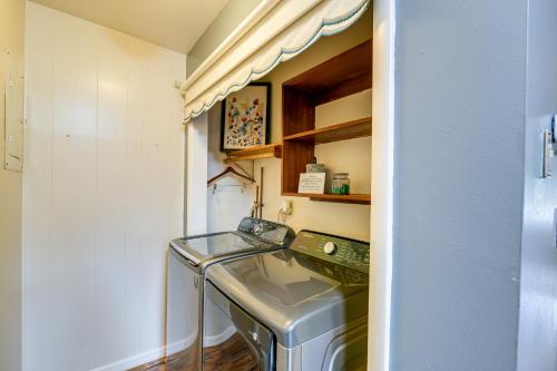 a small laundry room with a washer and dryer at Anchorage Home about 7 Mi to Chugach State Park! in Anchorage