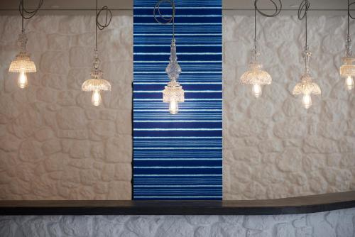 a row of chandeliers with blue and white stripes at Fresh Hotel, a member of Design Hotels in Athens