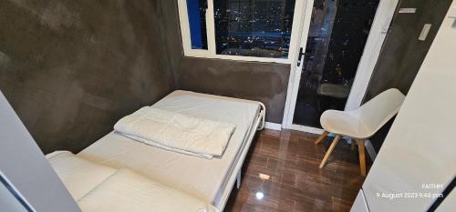 a small room with a bed and a window at SMDC AIR RESIDENCES in Manila