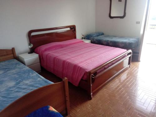 a bedroom with two beds and two ottomans at Villetta Alberti in Sanremo