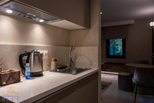 a kitchen with a sink and a counter top at Moustheni Blue Guest House in Mousthéni