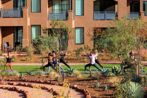 a group of people doing yoga in a park at The Wilde Resort and Spa in Sedona