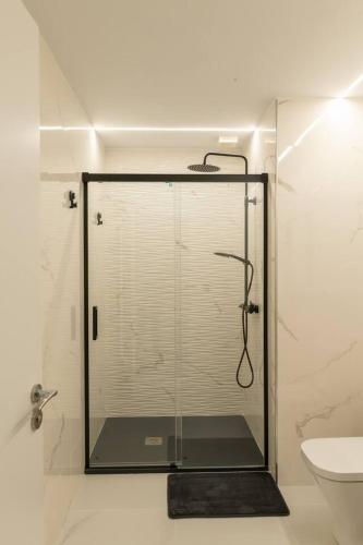 a shower with a glass door in a bathroom at Casa Tía Pepa in Castenda