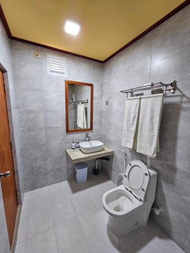 a bathroom with a toilet and a sink at White Sand Inn in Maamigili