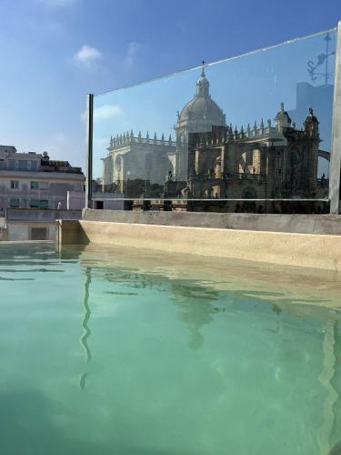 a pool of water with a view of a building at Catedral Suites Jerez in Jerez de la Frontera