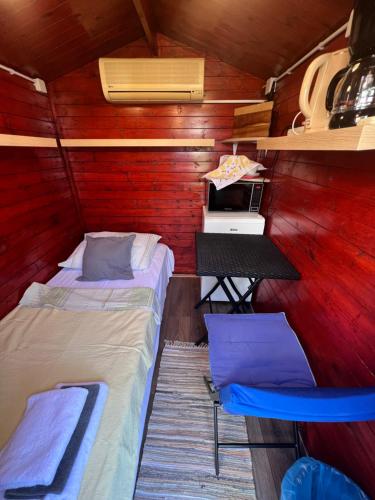 a small room with two beds and a desk at Apartments and bungalows vila Dalibor in Nin
