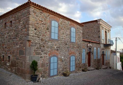 a large brick building with many windows on it at Hera Hotel in Bergama