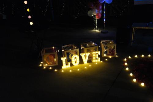 a sign that says love with lights in the dark at Xu Xu Homestay in Chiayi City