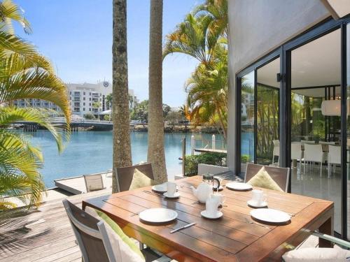 a wooden table with chairs and a view of the water at 15 Witta Circle in Noosa Heads
