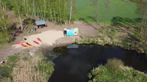 an aerial view of a camp site next to a pond at Agroturystyka Włochate Ranczo in Mochowo