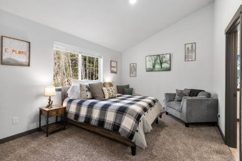 a bedroom with a bed and a couch and a window at Hikers Haven with Hot Tub - Near Mt Rainier! in Ashford