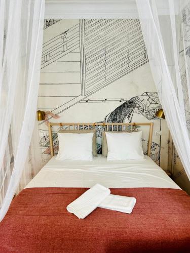 a bed with two white towels on top of it at Ultracentral Lux Boutique 1BR Ap Near Subway in Bucharest