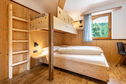 a bedroom with bunk beds in a cabin at Forchnerhof Apt 3 in Terento
