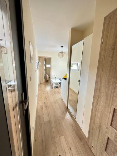 a hallway with a door leading to a living room at Wyspa Wisła Przyjazna Przystań Stężyca in Stężyca