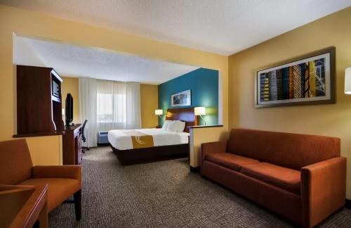 a hotel room with a bed and a couch at Quality Inn & Suites Bozeman in Bozeman