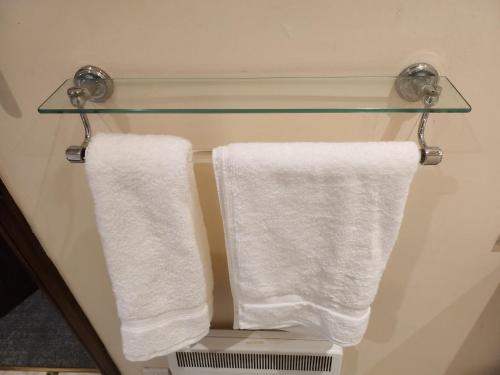 two towels hanging on a towel rack in a bathroom at Curry Mallet Cottages in Taunton