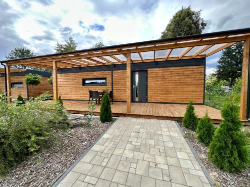 a contemporary home with a wooden pergola at Wyspa Wisła Przyjazna Przystań Stężyca in Stężyca