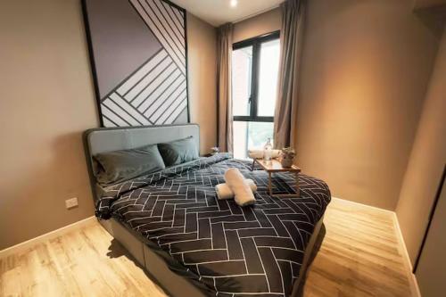 a bedroom with a large bed with a large window at Millerz Cozy Home by GUESTONIC in Kuala Lumpur