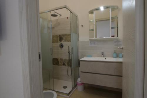 a bathroom with a shower and a sink at Pratza Froria in Villasimius