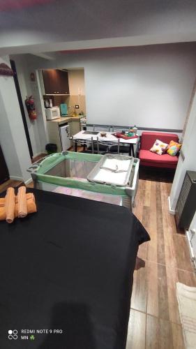 a living room with a glass table and a couch at EnSueños Bariloche in San Carlos de Bariloche