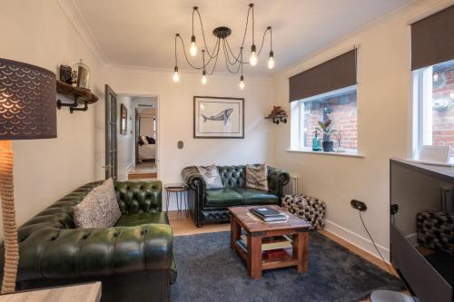 a living room with a couch and a table at Stunning- The Nautilus Bungalow Cowes IOW in Cowes