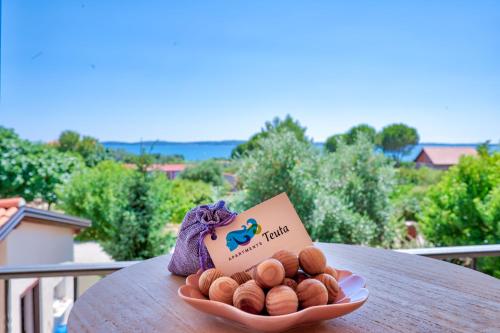 Teuta Apartments - a beach and a sea view