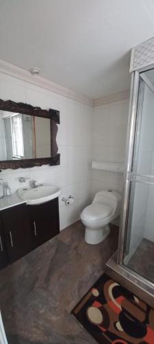 a bathroom with a toilet and a sink at villa concha in Paipa