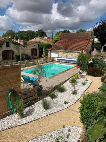 a swimming pool in a yard with a house at Gite de campagne rénové in Le Champ-Saint-Père