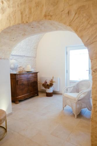 a living room with a chair and a table at Iconica Luxury Suites in Alberobello