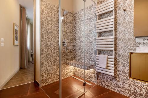 a bathroom with a glass shower with towels at La Magrè in Gargnano