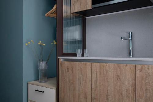 a bathroom with a sink and a vase with flowers at Bob W London Tower Hill - Studios in London