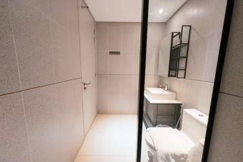 a small bathroom with a sink and a mirror at Millerz Cozy Home by GUESTONIC in Kuala Lumpur
